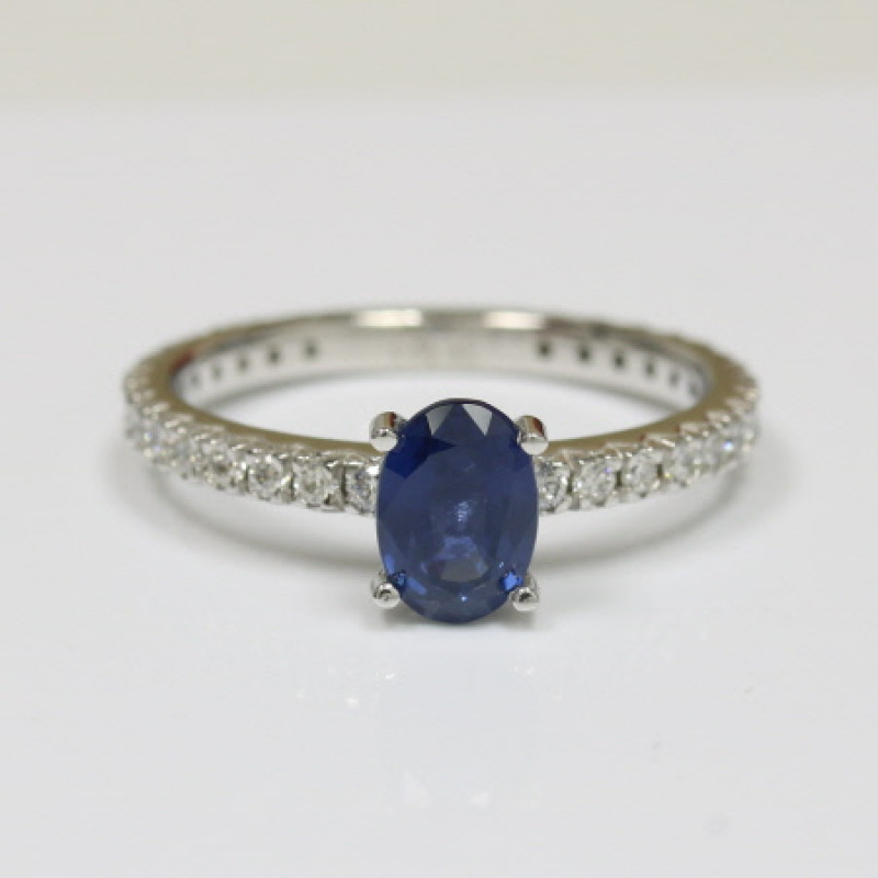 Royal Blue Beauty: Oval Sapphire Ring with Round Diamond Border: 